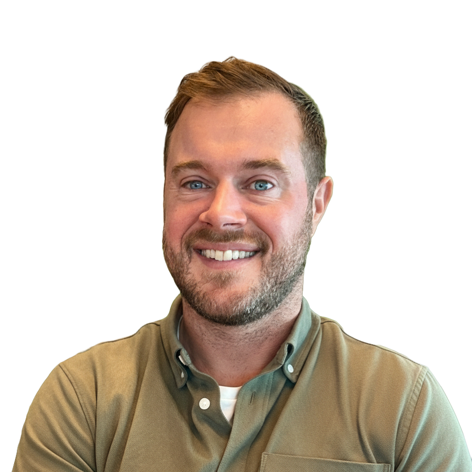 Patrick Cushing wearing a green polo shirt and smiling